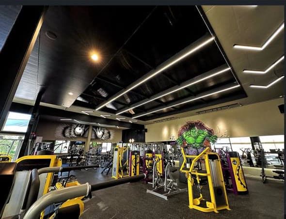 The machine floor at Gymmagic with yellow machines and the Hulk mural