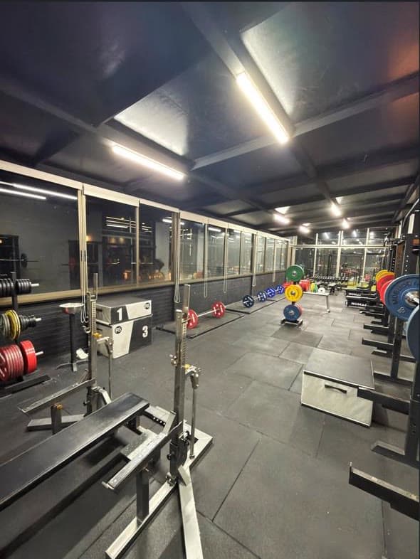 The new powerlifting area at Gymmagic with competition racks and calibrated plates